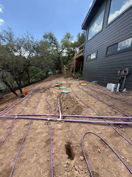 Aerobic septic drip-field lines installed beside a Central Texas home